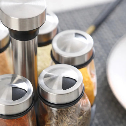 Juego de especiero giratorio: 7 botellas de vidrio para condimentos y saleros con soporte, organizador de cocina multifuncional y fácil de instalar.