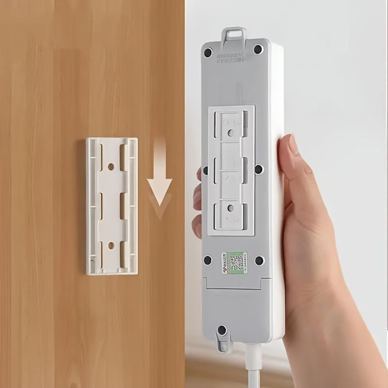 Organizador de enchufes autoadhesivo que ahorra espacio con gestión de cables: fácil de instalar, no daña el soporte de pared.