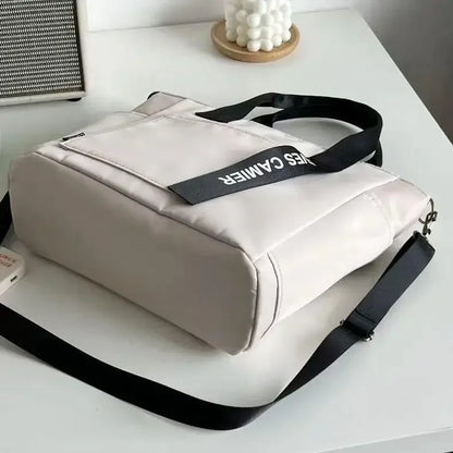 Nuevo bolso de hombro informal de gran capacidad, de nailon, impermeable, de lona, ​​sencillo y moderno, para colegiala.
