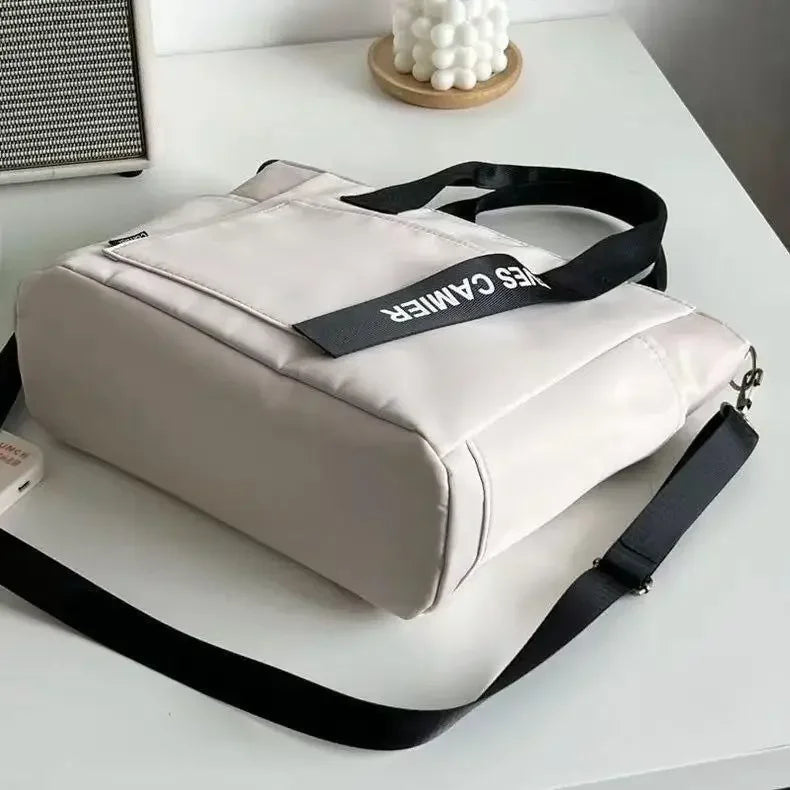 Nuevo bolso de hombro informal de gran capacidad, de nailon, impermeable, de lona, ​​sencillo y moderno, para colegiala.