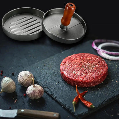 Prensa para hamburguesas de acero inoxidable con mango de madera antiadherente y 100 hojas de papel.