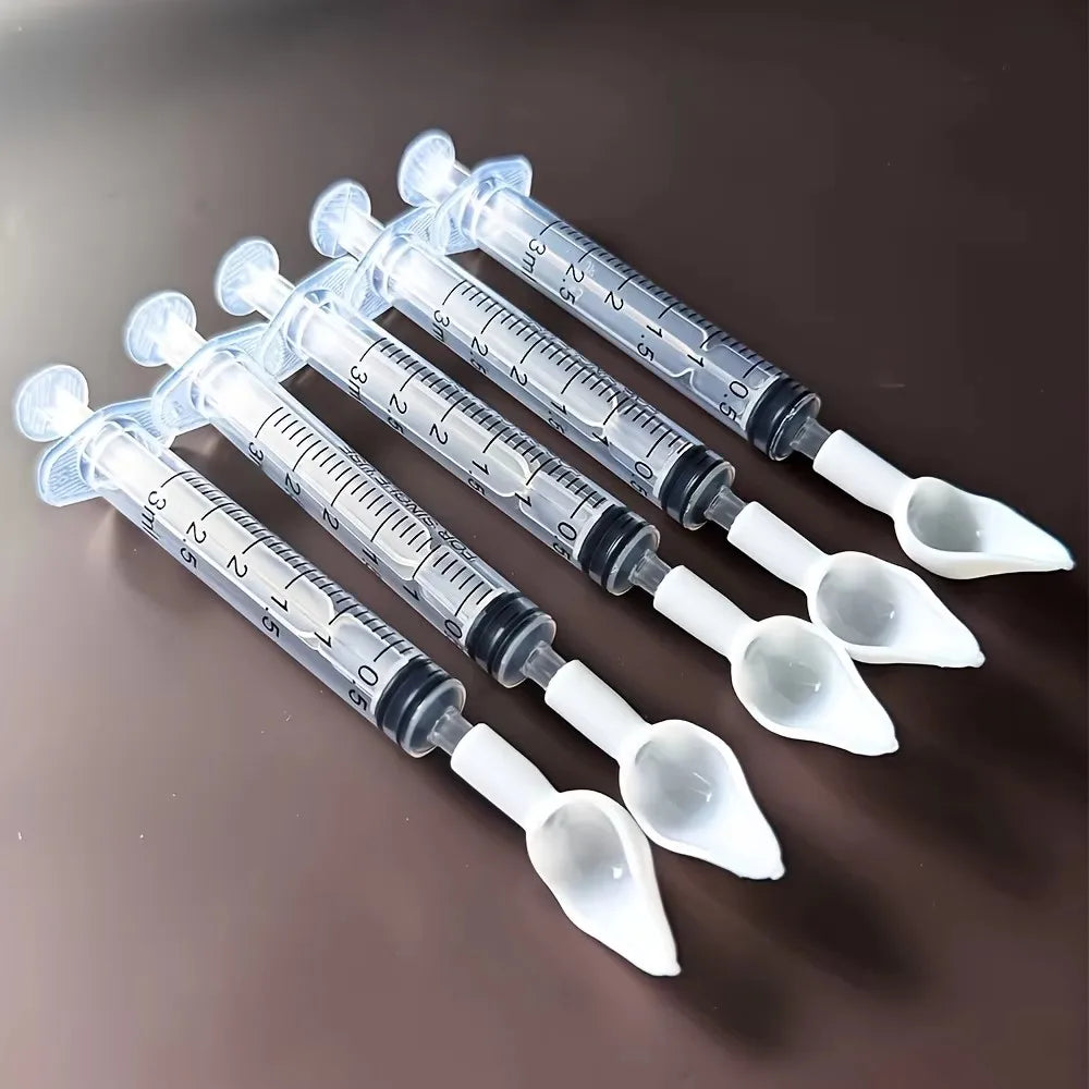 Bird medication feeding kit in a box, 10 feeding tubes, 5 syringes, 5 small spoons, 1 large spoon, measuring cup, and box