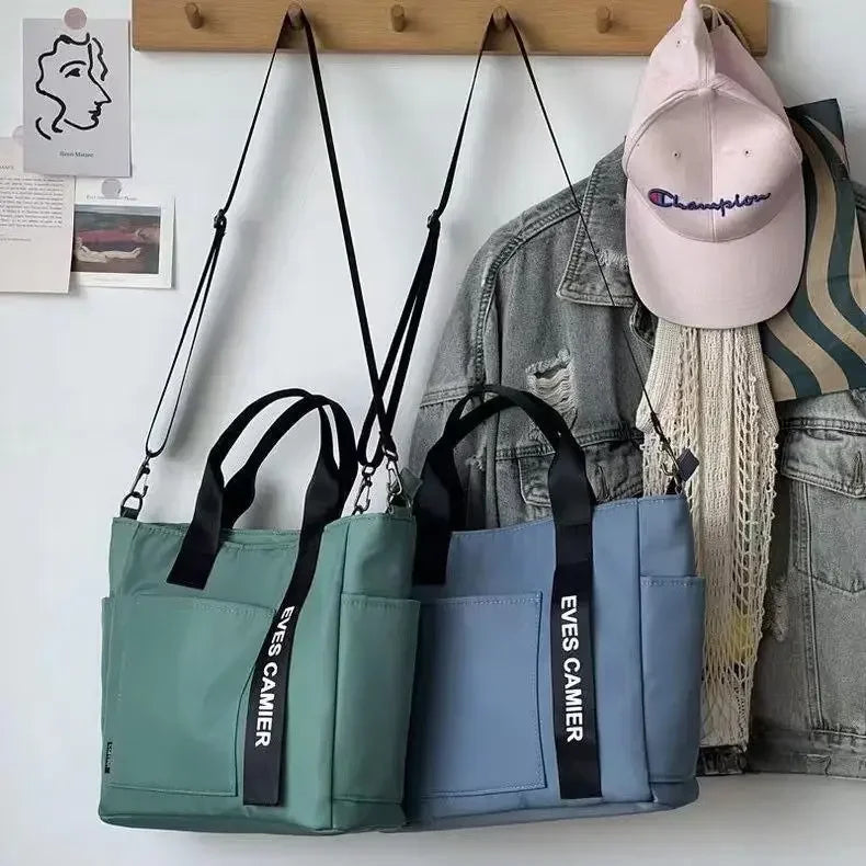 Nuevo bolso de hombro informal de gran capacidad, de nailon, impermeable, de lona, ​​sencillo y moderno, para colegiala.