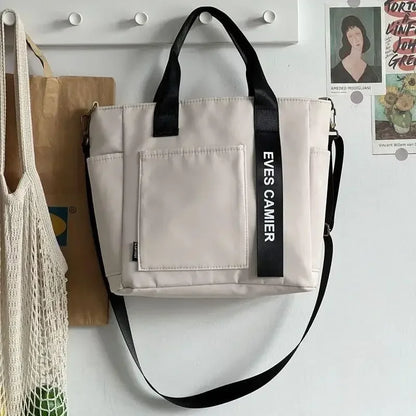 Nuevo bolso de hombro informal de gran capacidad, de nailon, impermeable, de lona, ​​sencillo y moderno, para colegiala.