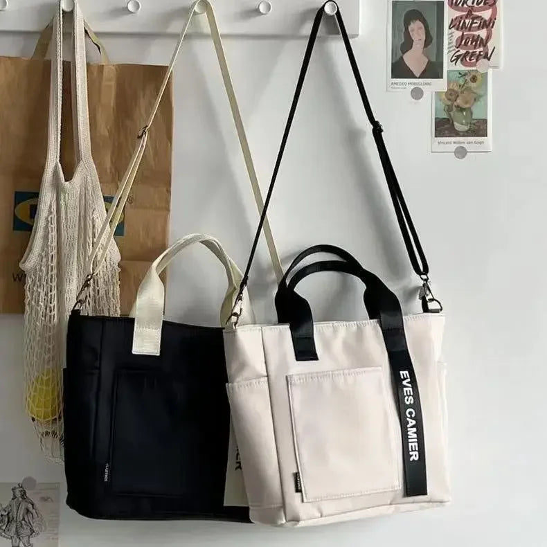 Nuevo bolso de hombro informal de gran capacidad, de nailon, impermeable, de lona, ​​sencillo y moderno, para colegiala.
