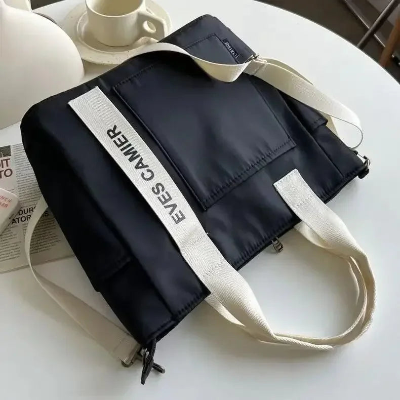 Nuevo bolso de hombro informal de gran capacidad, de nailon, impermeable, de lona, ​​sencillo y moderno, para colegiala.