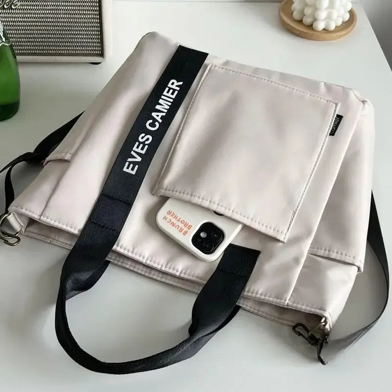 Nuevo bolso de hombro informal de gran capacidad, de nailon, impermeable, de lona, ​​sencillo y moderno, para colegiala.