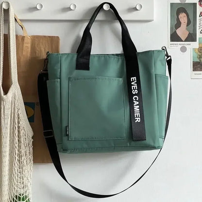 Nuevo bolso de hombro informal de gran capacidad, de nailon, impermeable, de lona, ​​sencillo y moderno, para colegiala.