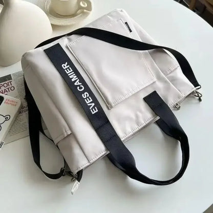 Nuevo bolso de hombro informal de gran capacidad, de nailon, impermeable, de lona, ​​sencillo y moderno, para colegiala.