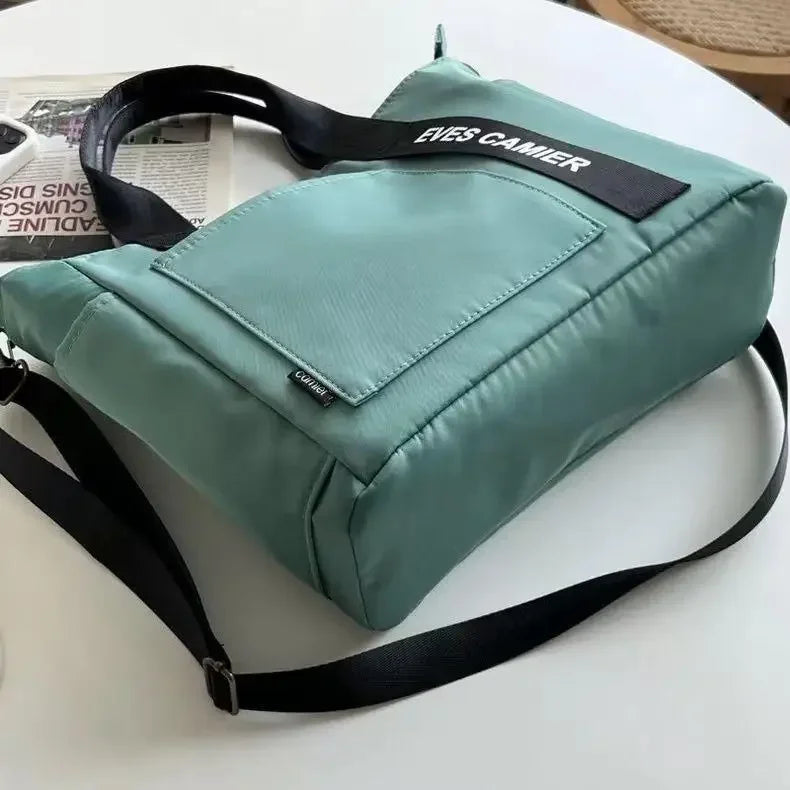 Nuevo bolso de hombro informal de gran capacidad, de nailon, impermeable, de lona, ​​sencillo y moderno, para colegiala.