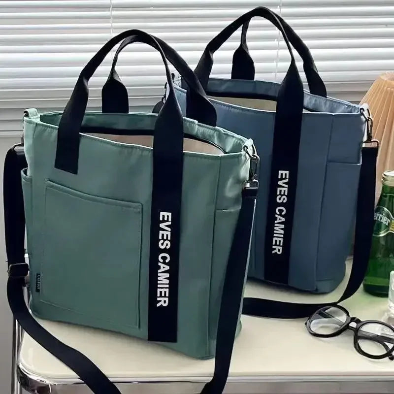 Nuevo bolso de hombro informal de gran capacidad, de nailon, impermeable, de lona, ​​sencillo y moderno, para colegiala.