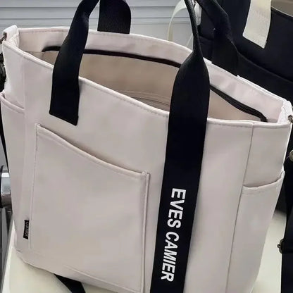Nuevo bolso de hombro informal de gran capacidad, de nailon, impermeable, de lona, ​​sencillo y moderno, para colegiala.