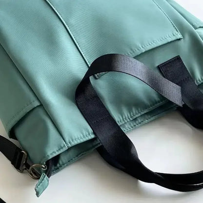 Nuevo bolso de hombro informal de gran capacidad, de nailon, impermeable, de lona, ​​sencillo y moderno, para colegiala.