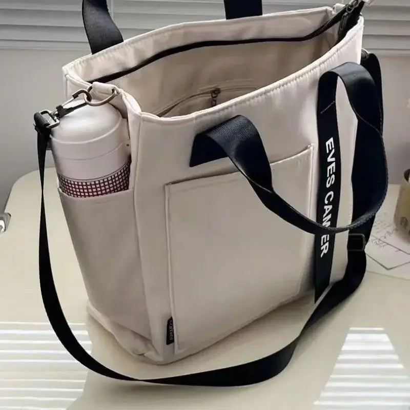 Nuevo bolso de hombro informal de gran capacidad, de nailon, impermeable, de lona, ​​sencillo y moderno, para colegiala.