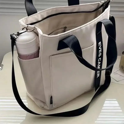 Nuevo bolso de hombro informal de gran capacidad, de nailon, impermeable, de lona, ​​sencillo y moderno, para colegiala.