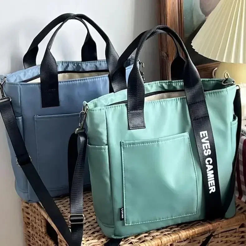 Nuevo bolso de hombro informal de gran capacidad, de nailon, impermeable, de lona, ​​sencillo y moderno, para colegiala.
