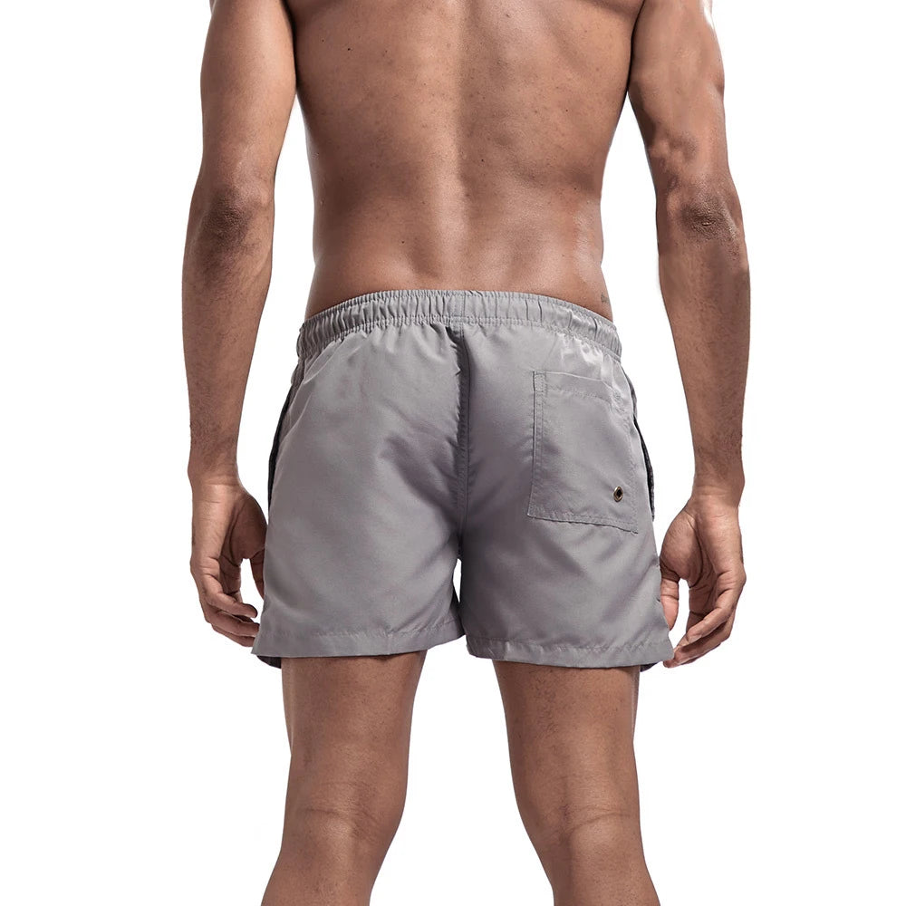 Bañador corto para hombre, de secado rápido, transpirable, con cordón y bolsillos para surfear en la playa en verano.