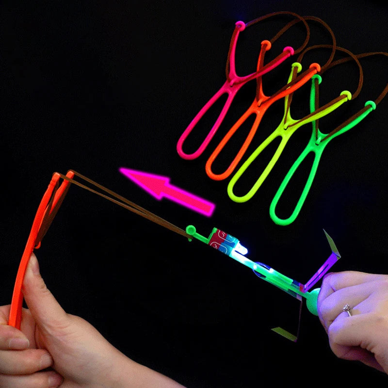 Increíble juguete luminoso, flecha LED, juguetes para fiestas al aire libre, divertido regalo, banda elástica, catapulta que brilla en la oscuridad, cohete, helicóptero, juguete volador.